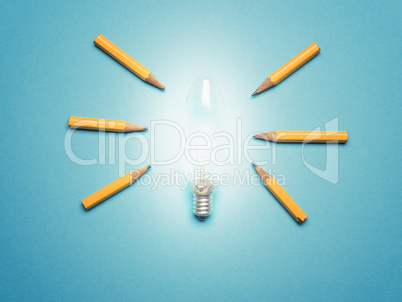 A glowing light bulb with 6 pencils as light rays, New ideas or