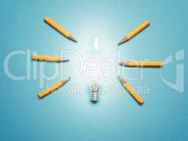A glowing light bulb with 6 pencils as light rays, New ideas or