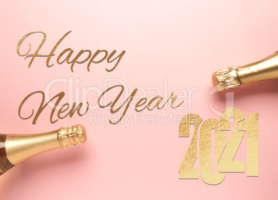 The words Happy New Year with golden 2021 and champagne