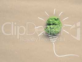 Recycled paper background with green crumpled paper ball as ligh