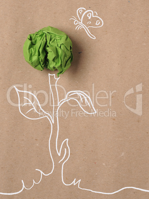 Recycled paper background with green crumpled paper ball as flow