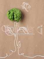 Recycled paper background with green crumpled paper ball as flow