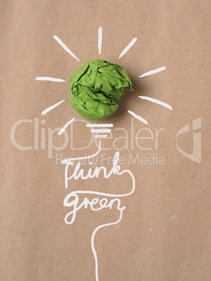 Recycled paper background with green crumpled paper ball as ligh