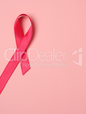Pink ribbon curl on a pink paper background ,symbol for Liver Ca