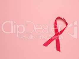 Pink ribbon curl on a pink paper background ,symbol for Liver Ca