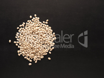 A heap of organic white beans on a blackboard with space for you