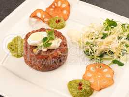 Beef tartare with a quail egg and fresh organic garden salad