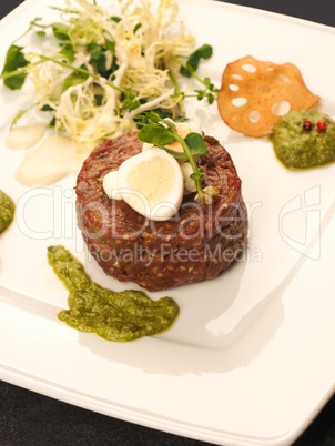 Beef tartare with a quail egg and fresh organic garden salad