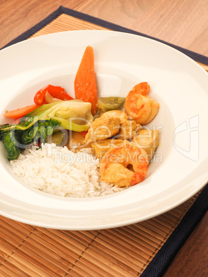 Red Thai curry with chicken and shrimps with fried vegetables an