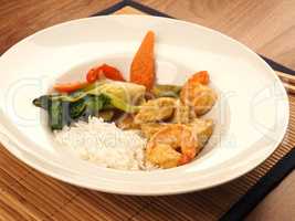 Red Thai curry with chicken and shrimps with fried vegetables an