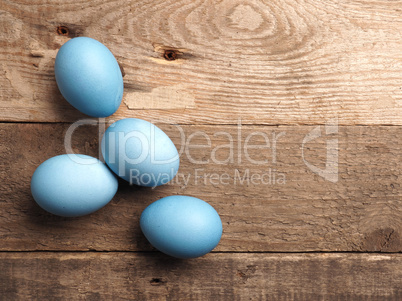 Naturally colored organic eggs on a rustic table