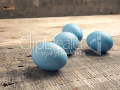 Naturally colored organic eggs on a rustic table