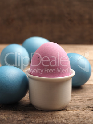 Naturally colored organic eggs on a rustic table