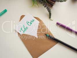 Personalized note with inscription Take Care in a natural color