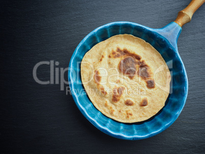 Delicious spelt pancake in a blue stoneware pan, too view