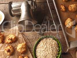 Oatmeal cookies on baking paper with organic baking ingredients