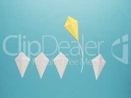 White paper kites in a row with a yellow paper kite flying away
