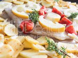 Cod fillet garnished with thyme garlic and tomatoes, preparation