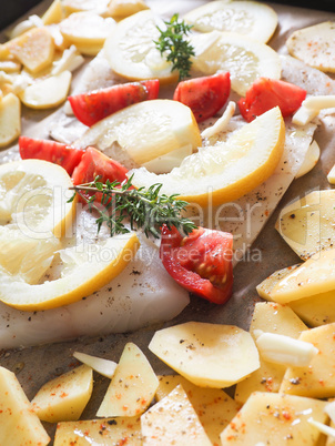 Cod fillet garnished with thyme garlic and tomatoes, preparation