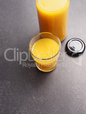 Organic orange juice on a stone table