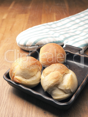 Baked yeast dough balls in a ceramic pan in a kitchen