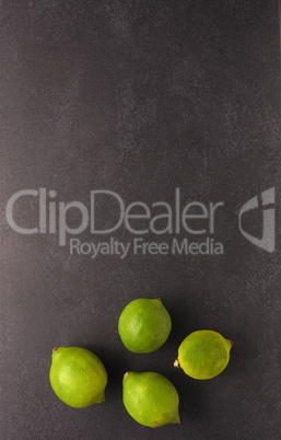 Fresh organic lime fruit on a dark stone table