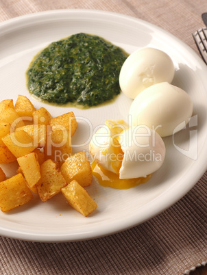 Organic spinach served with spicy potato cubes and boiled organi