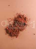 Chocolate powder on a brown background, top view