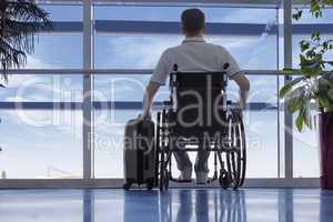 Young man in a wheelchair at the airport