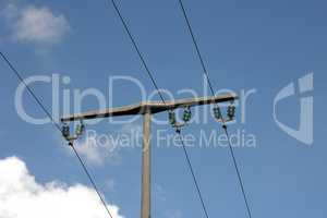 Power transmission masts against a blue sky