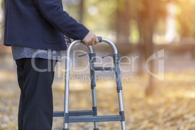 Woman with walker walking outdoors closeup