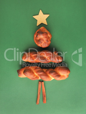 Yeast pastry decorated as Christmas tree on a green background