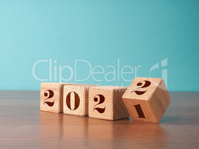 Flipping wooden cubes with the Year number 2021 and 2022, New Ye