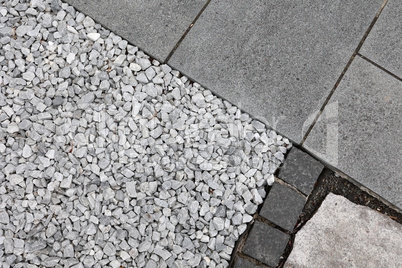 Part of a street with gray tiles and stones