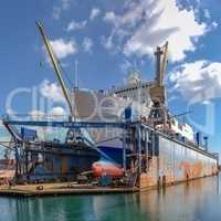 Large ship in dry dock of shipyard