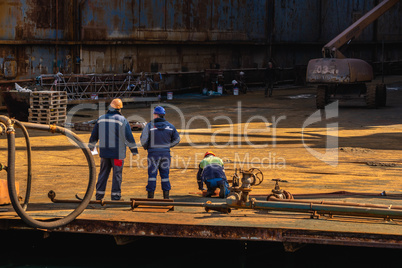 Dry dock workers in a Shipyard