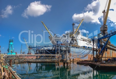 Large ship in dry dock of shipyard