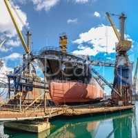 Large ship in dry dock of shipyard