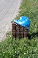 Dustbin in Park at dry sunny summer day