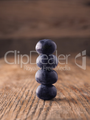 Fresh organic blueberries stacked on a wooden table
