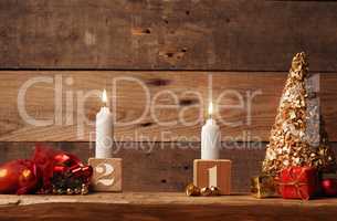 Second Advent candle burning on a rustic wooden table