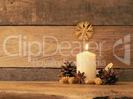 First Advent candle burning on a rustic wooden table