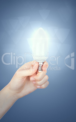 Female hand holding a light bulb