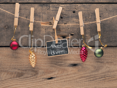 Colorful Christmas balls on a line with a small blackboard
