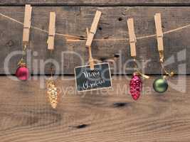 Colorful Christmas balls on a line with a small blackboard