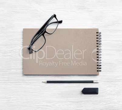 Kraft notebook, glasses, pencil, eraser