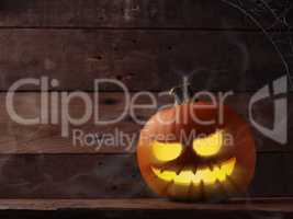 Carved halloween pumpkin Jack o lantner on a rustic wooden table
