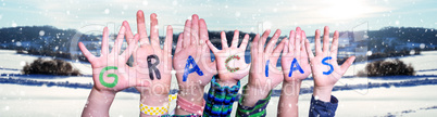 Children Hands Building Word Gracias Means Thank You, Snowy Winter Background