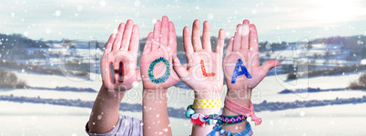 Kids Hands Holding Word Hola Means Hello, Snowy Winter Background
