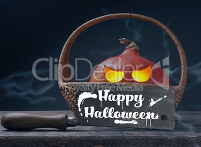 Carved halloween pumpkin Jack o lantner in a basket on a rustic